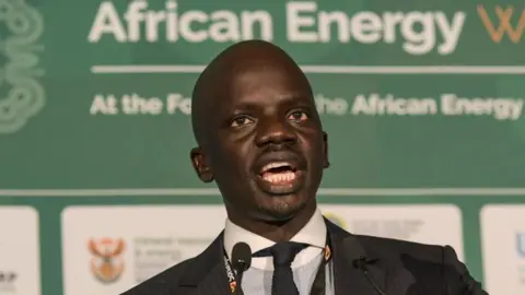 A close up of Minister of Petroleum Puot Kang Chol in a dark suit.