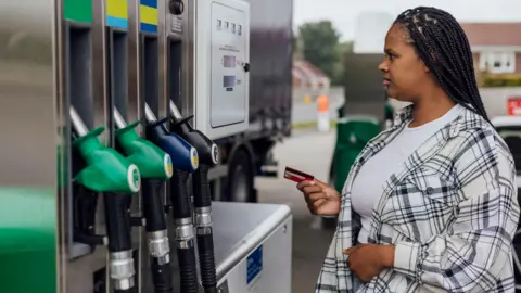 Getty Images A driver paying for their petrol at a fuel pump