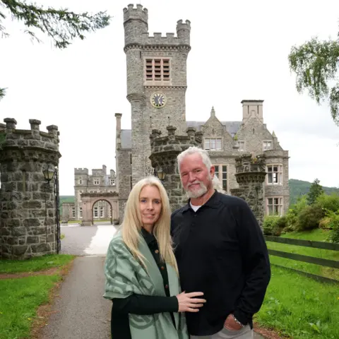 Thorntons Suzanne and Lance at the gates to the castle.