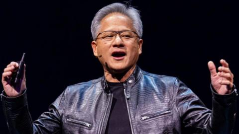 Nvidia chief executive Jensen Huang on stage in black leather jacket and black t-shirt