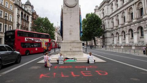 Two were videoed spray painting the tarmac in front of the Cenotaph
