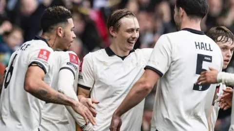 Port Vale's players celebrate after scoring against Sunderland in the FA Cup