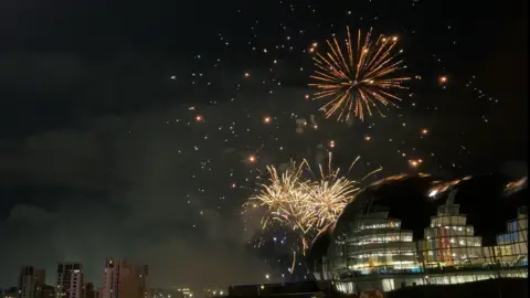 NE1 Fireworks behind The Glasshouse in Gateshead on the Quayside. They light up the night sky.