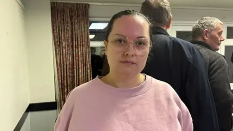 Daniel Sexton/BBC Sarah wears pink top and glasses