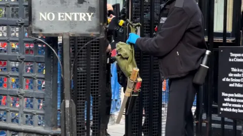 Knives on a bag, held by a person wearing black.