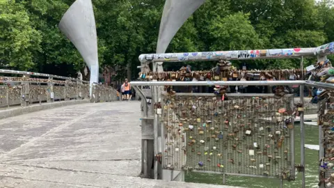 Many padlocks attached to Pero's Bridge. The picture is taken from one end of the bridge looking in the direction of Queen Square