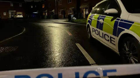 BBC Police car outside a crime scene 