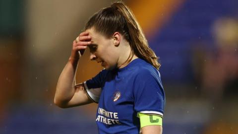 Chelsea captain Niamh Charles holds her hand to her head