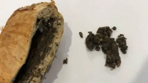Supreme Court of Victoria Beef Wellington cut open with filling exposed on left of image and some of the filling out on the right