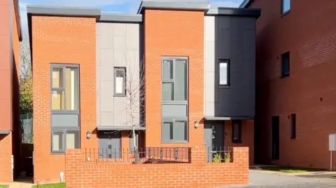 An image of red brick homes known as Heath Town