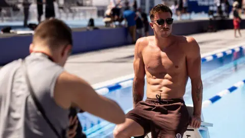  Irish swimmer Max McCusker poses in front of a swimming pool at the Enhanced Games