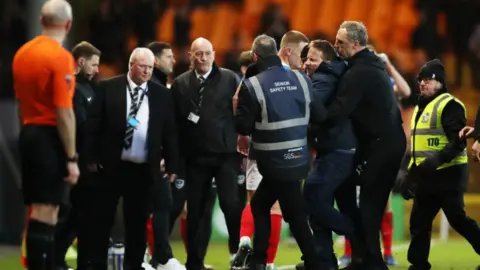 PA Media Officials respond to Port Vale pitch invader