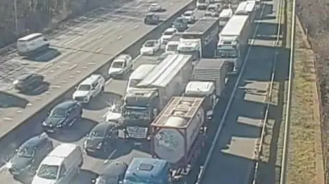 National Highways A traffic camera images shows the anticlockwise lane is full of stationary cars and lorries. 