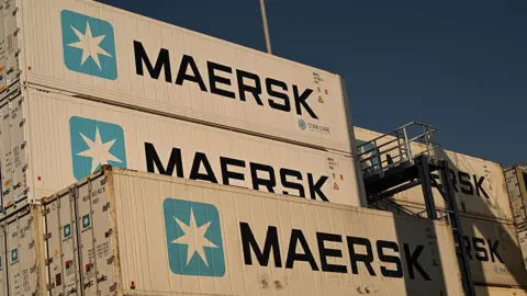 AFP via Getty Images A stack of shipping containers with Maersk signs on the side