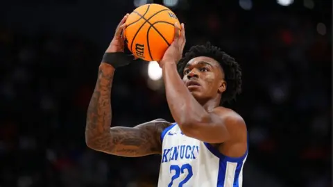 Amari Williams #22 of the Kentucky Wildcats wear a white vest with blue lettering