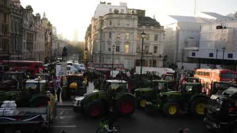 Jordan Pettitt/BBC Wide shot of tractors on Central London street with buses around them