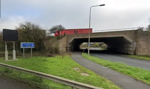 Entrance to motorway sliproad showing bridge carrying M1 over an A road