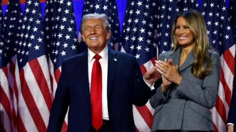 Getty Images Donald and Melania Trump on stage at the Palm Beach Convention Center