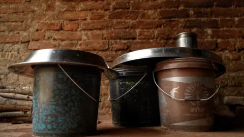 Seraj Ali The water buckets at Mamta's home 