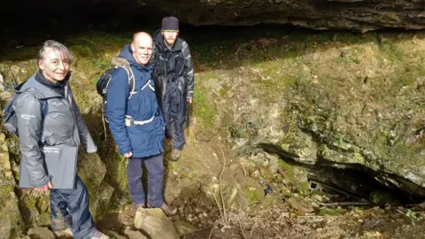 Yorkshire Dales National Park Authority Rick Peterson with archaeologist colleagues at one of the cave sites on Ingleborough.