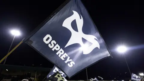 An Ospreys flag is flown at a game