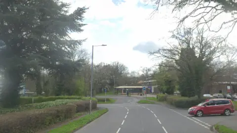 Google Maps Studley Road bends around to the left as a car sits at a junction on the right side of the road.