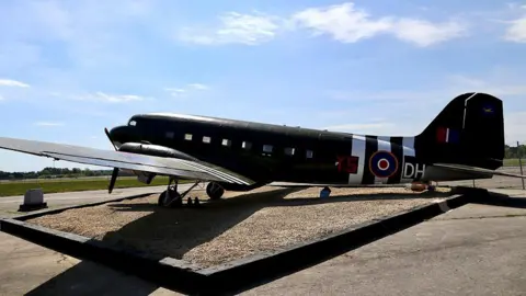 RAF Brize Norton A side view of the restored Dakota Gate Guardian at RAF Brize Norton 47 Air Despatch Royal Logistic Corps in Oxfordshire on a sunny day.