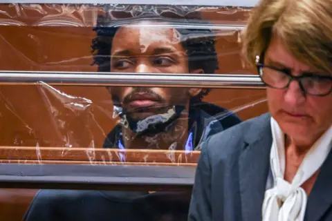 Getty Images D4vd appears behind a clear plastic sheet in an LA courtroom during preliminary hearings into the murder charge he faces