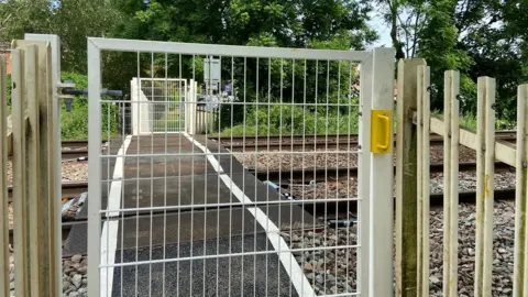 Network Rail A closed gate in front of a footpath level crossing in Burton Joyce, Nottinghamshire