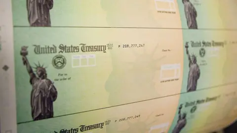 Getty Images Economic stimulus checks are prepared for printing at the Philadelphia Financial Centre