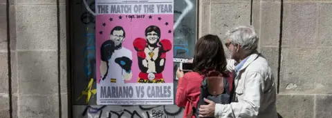 AFP A poster showing Spanish Prime Minister Mariano Rajoy (L) and President of the Catalan Government Carles Puigdemont, on September 16, 2017 in Barcelona