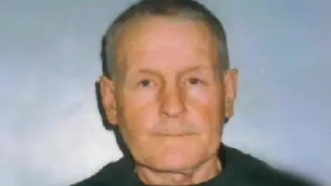 Police Head and shoulders shot of Brian Field in a dark top and with short, greying hair