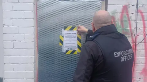 Stockton-on-Tees Borough Council An enforcement officer attaches a closure order on the property in Teesdale Terrace in Thornaby