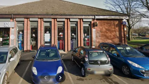Google Four cars parked outside a Co-op supermarket
