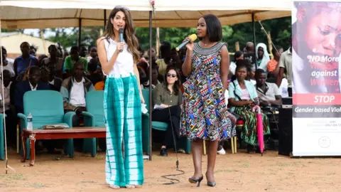 Neil Rasmus Amal Clooney and human rights lawyer Chikondi Chijozi at the mobile legal clinic in Mchinji district