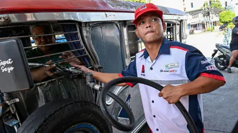 Getty Images A driver refuels his vehicle with diesel at a fuel station in Manila 