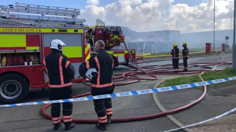 Kate Bradbrook/BBC Fire crews at a blaze in Corby, Northamptonshire 