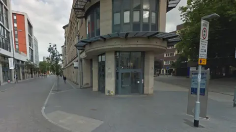 Google A paved street with a traffic restriction sign