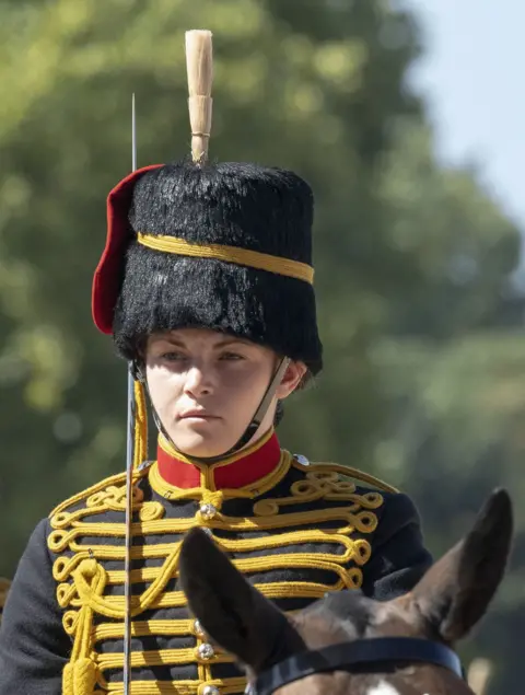 Ministry of Defence Ciara Sullivan, a young woman, is pictured on horseback in ceremonial military uniform 