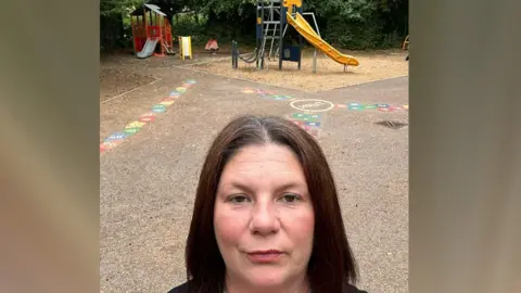 Kirsty Knight A selfie of Kirsty Knight in front of the play equipment in the park 