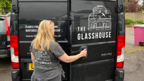 BBC/Phil Harrison Rhi putting plants into a Glasshouse van