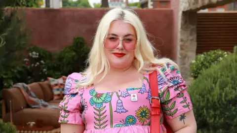 Getty Images blonde woman wearing a pink pink rosy sunglasses