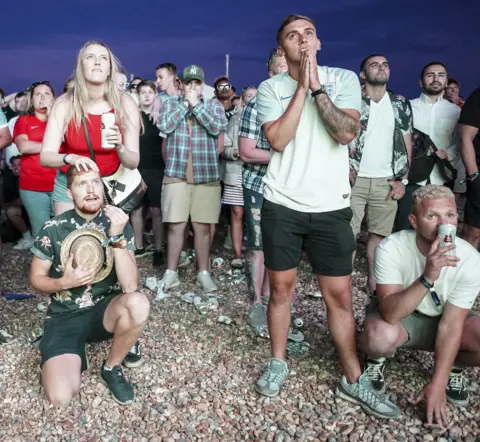Getty Images England fans celebrate on Brighton beach
