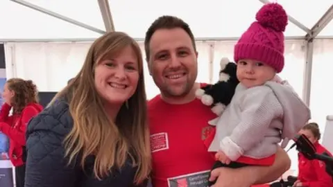 family photo Dean Fletcher with wife Katie and their daughter Evie posed for a picture before the race