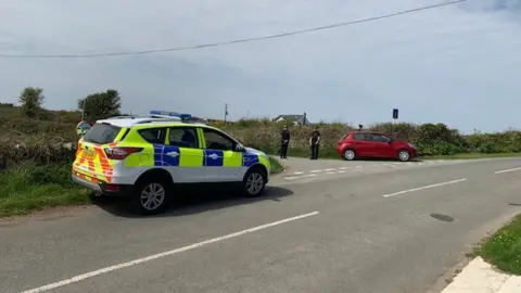 North Wales Police Police at the scene of the incident near South Stack Road