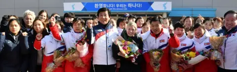 Reuters Sarah Murray, head coach of the combined women's ice hockey team, is seen as the North Korean women's ice hockey players arrive at South Korea's national training centre in Jinchoen on 25 January 2018