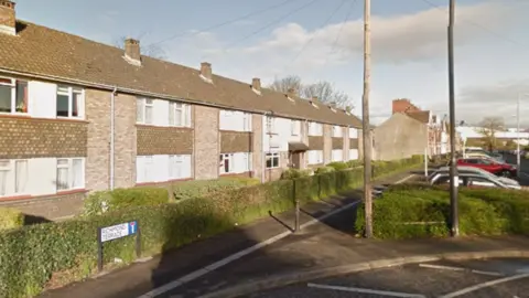 Google A row of terraced houses or flats on a residential street. A road sign in the foreground says 'Richmond Terrace'. 