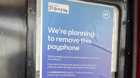 Clare Worden/BBC Purple notice with white writing inside the phone box reads: "We're planning to remove this payphone. Unfortunately, it just isn't used enough for us to carry on running it." It invites people who object to contact their local authority within 90 days of the date on the notice, 31/10/24.