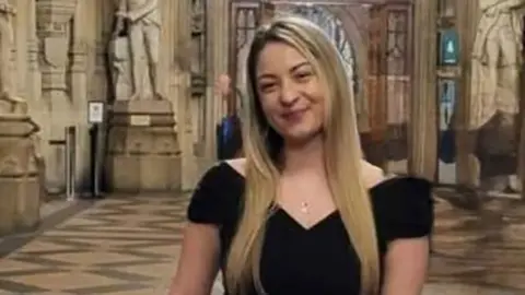 Shinead Francis she has long blonde hair and is wearing a black top.