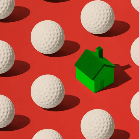BBC A red background covered in white golf balls with a green house
